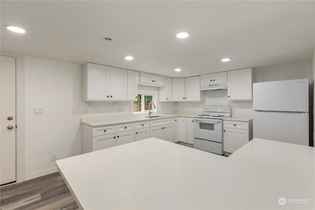 kitchen featuring recessed lighting, white cabinetry, a sink, white appliances, and under cabinet range hood