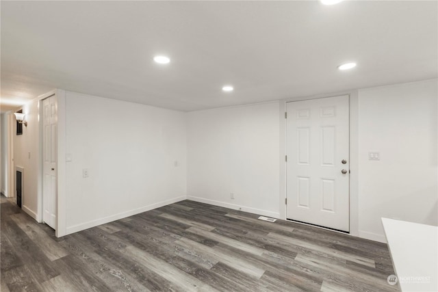 spare room with recessed lighting, dark wood finished floors, and baseboards