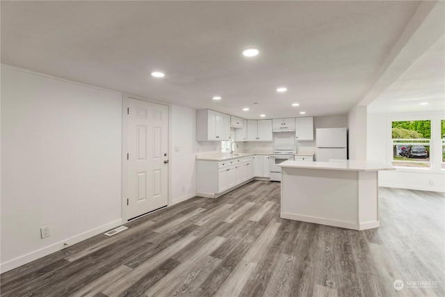 kitchen with white appliances, baseboards, dark wood-style flooring, and white cabinetry