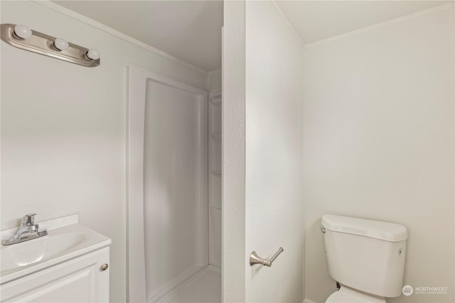 bathroom featuring walk in shower, vanity, toilet, and crown molding