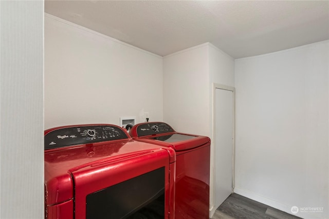 clothes washing area featuring laundry area, washing machine and dryer, a textured ceiling, and wood finished floors