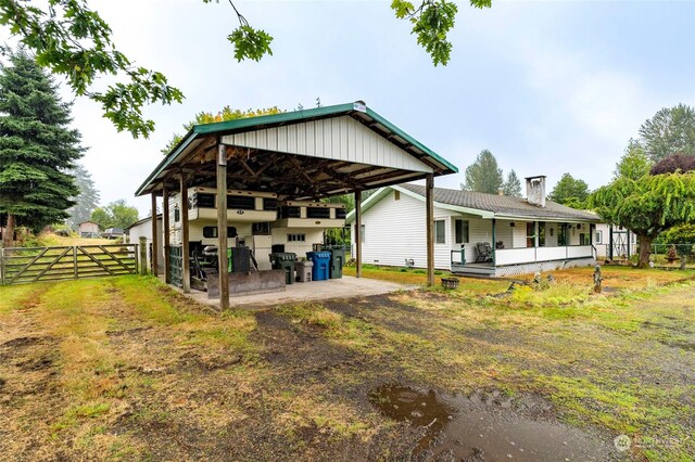 back of property featuring a carport