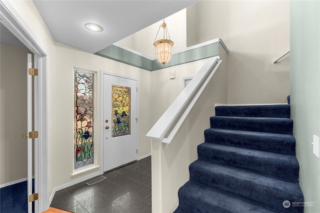 foyer with dark tile patterned floors