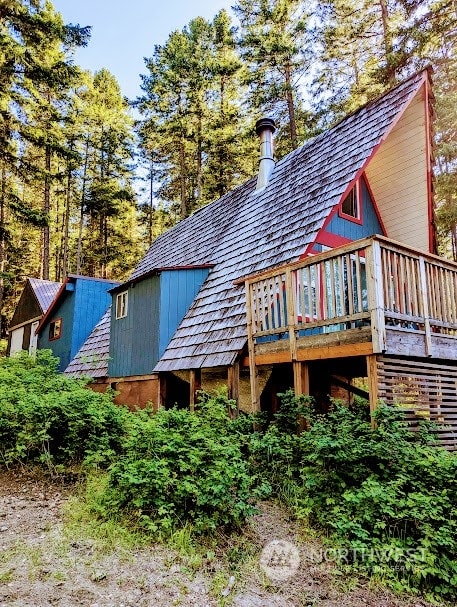 rear view of house featuring a deck