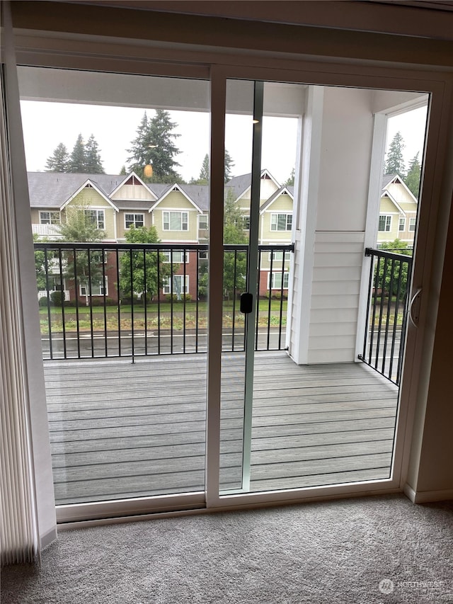 doorway featuring carpet floors