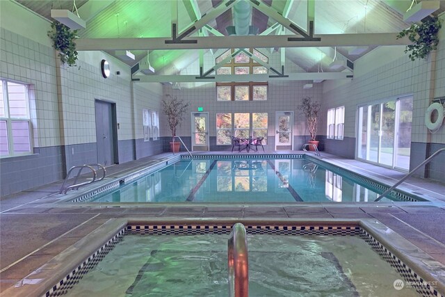 view of pool with an indoor hot tub