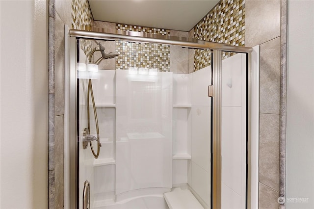 bathroom featuring a shower with shower door