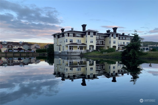 back house at dusk with a water view