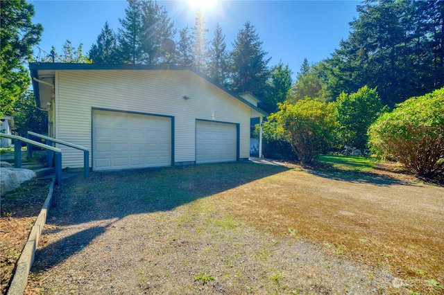 garage featuring a lawn