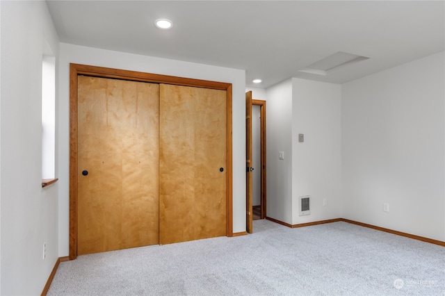 unfurnished bedroom with carpet floors and a closet