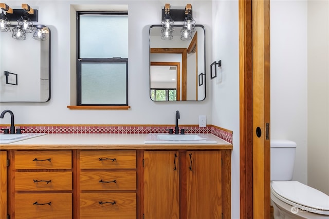 bathroom featuring plenty of natural light, vanity, and toilet