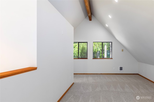 bonus room featuring lofted ceiling with beams and light carpet