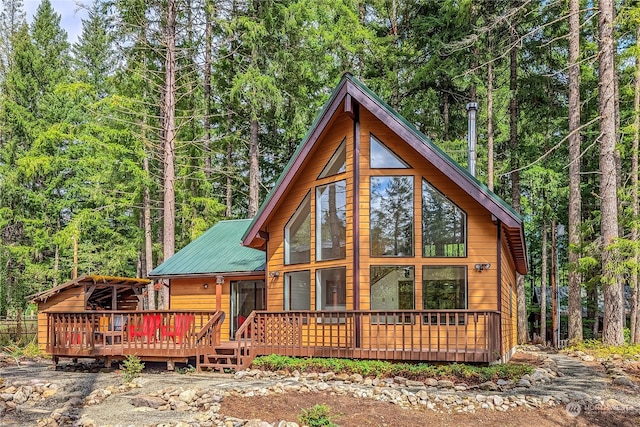 rear view of house with a wooden deck