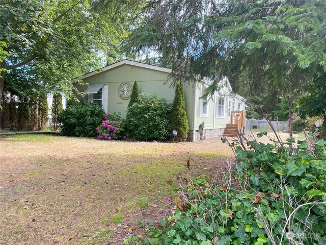 view of home's exterior with a lawn