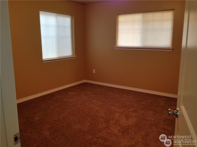 carpeted spare room featuring baseboards and a healthy amount of sunlight