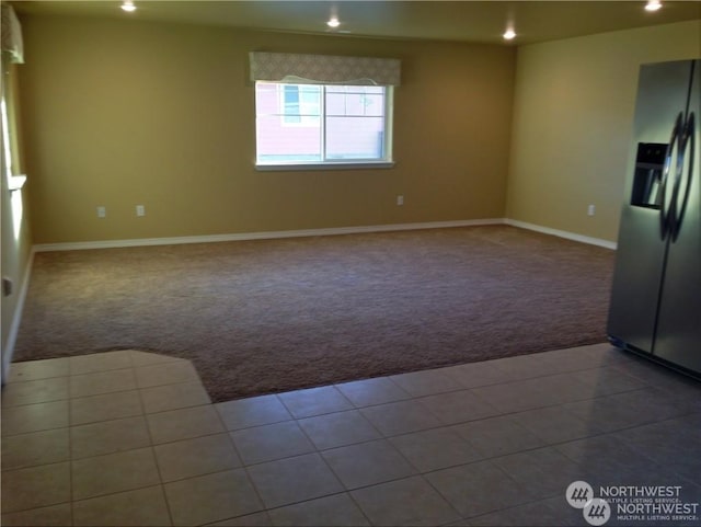 carpeted spare room featuring tile patterned flooring, baseboards, and recessed lighting