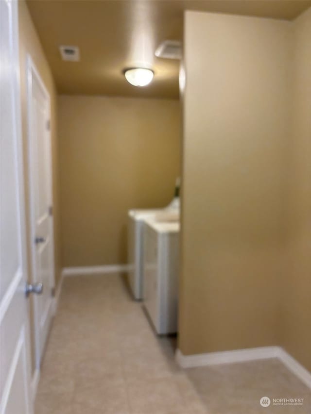 laundry room with laundry area, baseboards, and washer and dryer