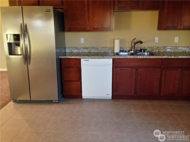 kitchen with stainless steel fridge, white dishwasher, a sink, and light tile patterned floors