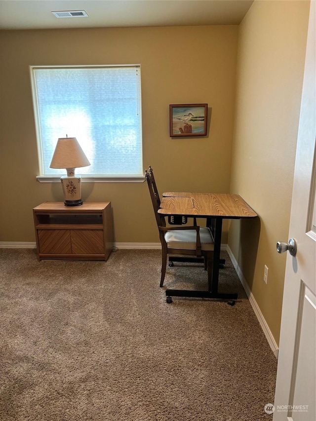 office featuring baseboards, visible vents, and carpet flooring