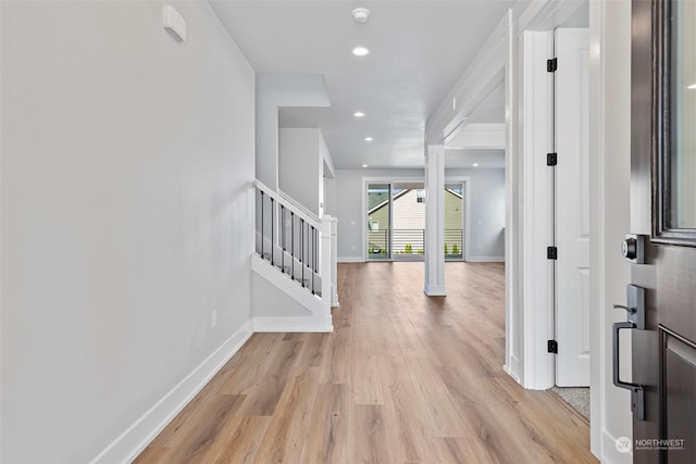 foyer featuring stairs, light wood-style floors, recessed lighting, and baseboards