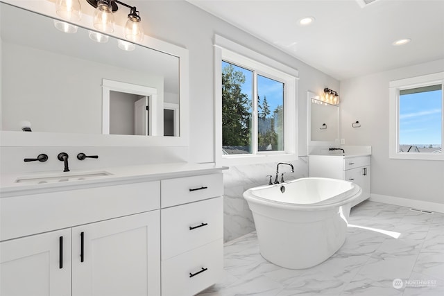 bathroom with tile walls, a bathtub, dual bowl vanity, and tile patterned floors