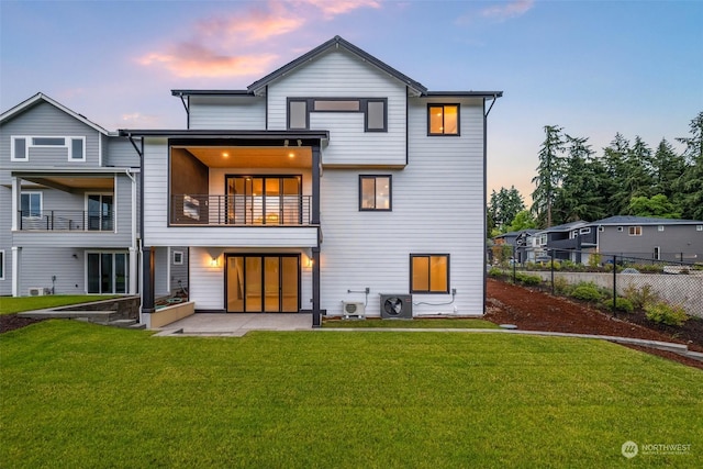 rear view of property with ac unit, a lawn, a patio area, and fence