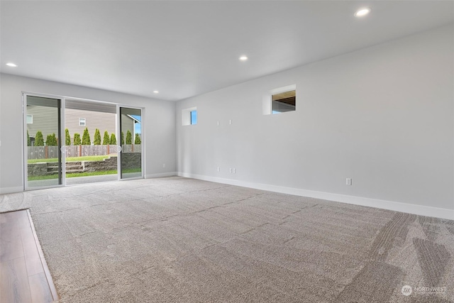 spare room with recessed lighting, carpet flooring, and baseboards