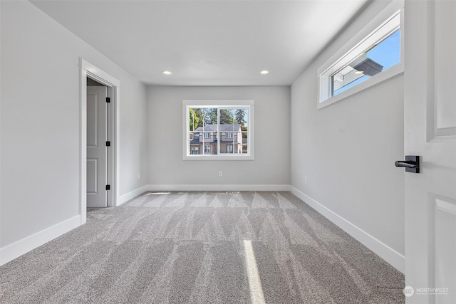 carpeted empty room featuring baseboards and recessed lighting