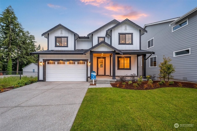 modern inspired farmhouse featuring driveway, a garage, fence, a front lawn, and board and batten siding