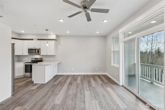 kitchen with ceiling fan, decorative light fixtures, light hardwood / wood-style floors, white cabinetry, and stainless steel appliances