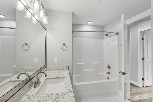 bathroom featuring bathtub / shower combination and vanity