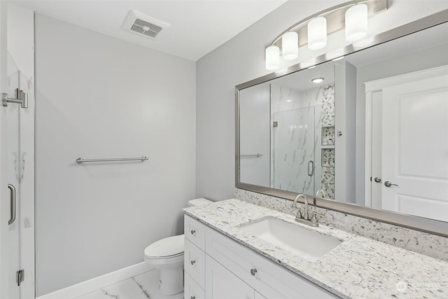 bathroom with vanity, toilet, and a shower with door