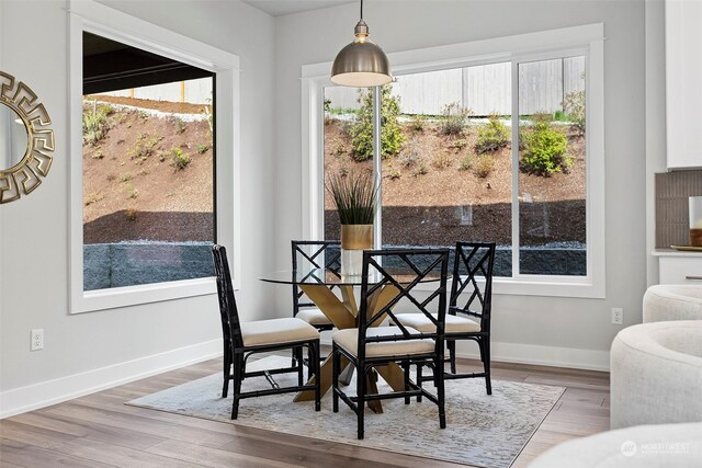 dining area featuring hardwood / wood-style flooring and a healthy amount of sunlight