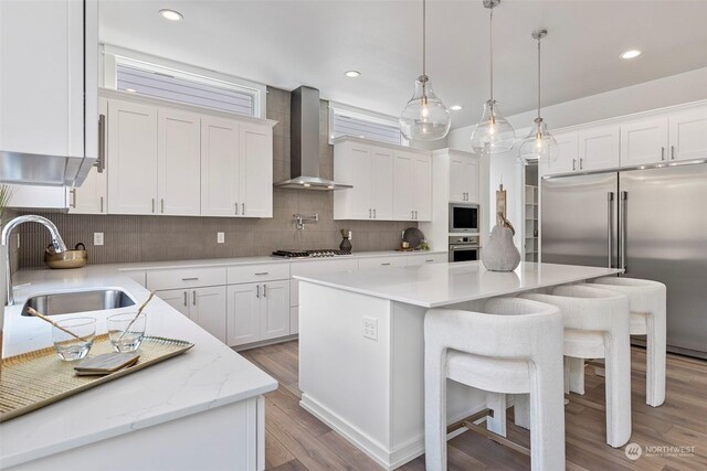 kitchen with a kitchen island, decorative backsplash, and wall chimney exhaust hood