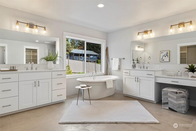 bathroom featuring a bathtub, tile patterned flooring, and vanity