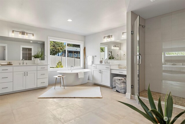 bathroom with tile patterned floors, separate shower and tub, and vanity