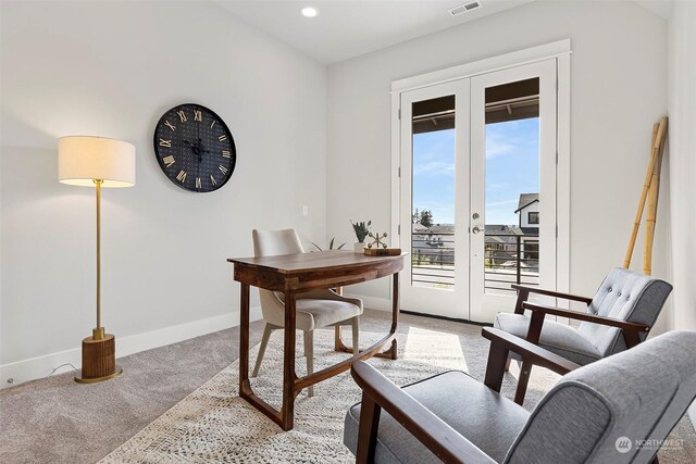 carpeted home office featuring french doors