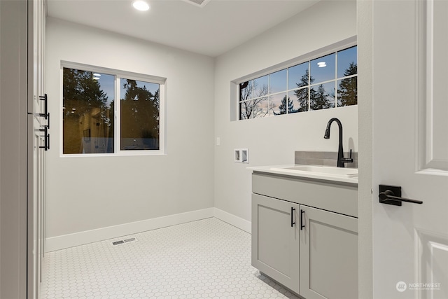 bathroom with tile patterned floors and vanity