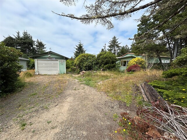 1411 300th Pl, Ocean Park, WA 98640 - view of yard with an outdoor structure and a garage