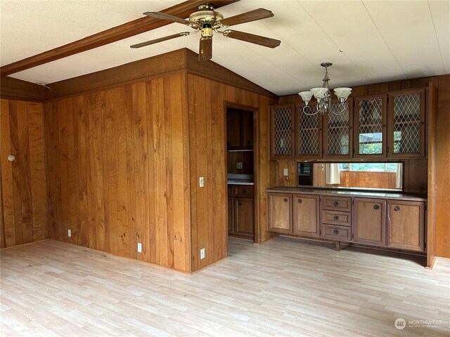 1411 300th Pl, Ocean Park, WA 98640 - kitchen with light hardwood / wood-style flooring, pendant lighting, wooden walls, ceiling fan with notable chandelier, and vaulted ceiling