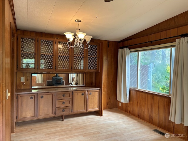 1411 300th Pl, Ocean Park, WA 98640 - kitchen featuring wood walls, vaulted ceiling, and an inviting chandelier