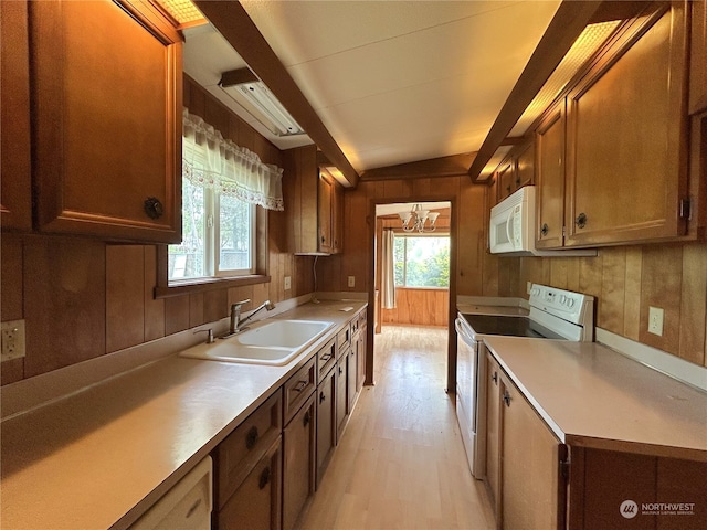 1411 300th Pl, Ocean Park, WA 98640 - kitchen with sink, light hardwood / wood-style flooring, wooden walls, and white appliances
