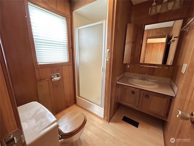 1411 300th Pl, Ocean Park, WA 98640 - bathroom with wood walls, hardwood / wood-style floors, toilet, and an enclosed shower