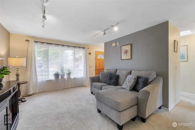 carpeted living room with track lighting