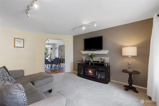 living room featuring an inviting chandelier and carpet flooring