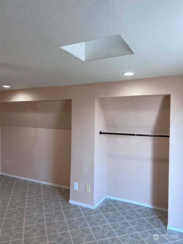 interior space featuring tile patterned flooring and a textured ceiling