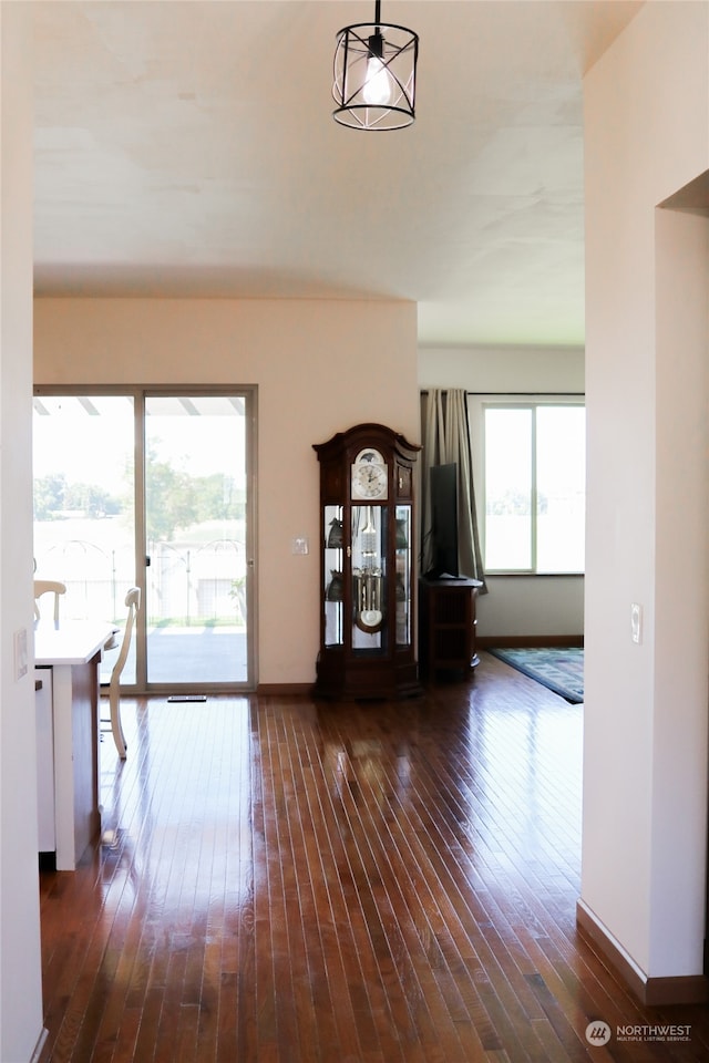 unfurnished living room with dark wood-type flooring