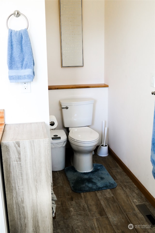 bathroom with wood-type flooring and toilet