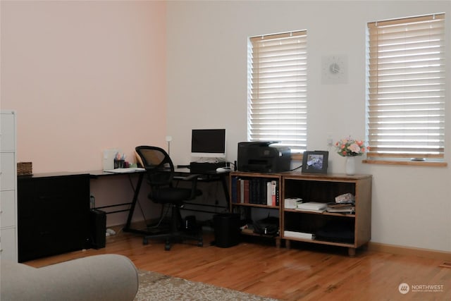 office space with wood finished floors and baseboards