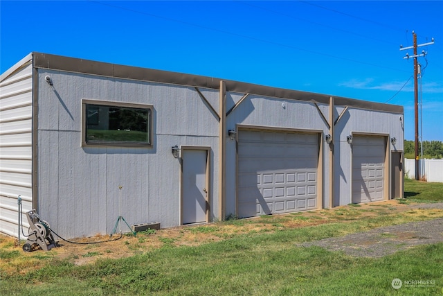 garage featuring a yard